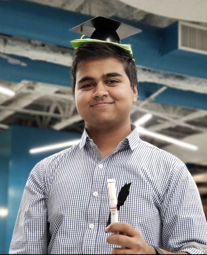 Picture of me holding a mini diploma and grad cap